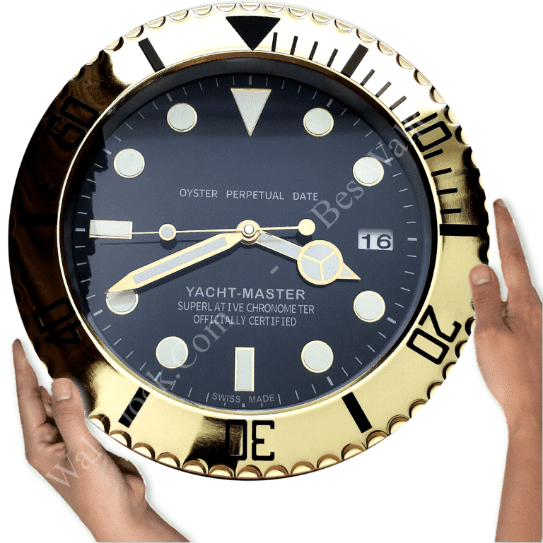 Two hands holding a large round wall clock designed like a Rolex Yacht-Master watch face with gold bezel and black dial showing the time as 8:14:44 with a date window displaying the number 16.