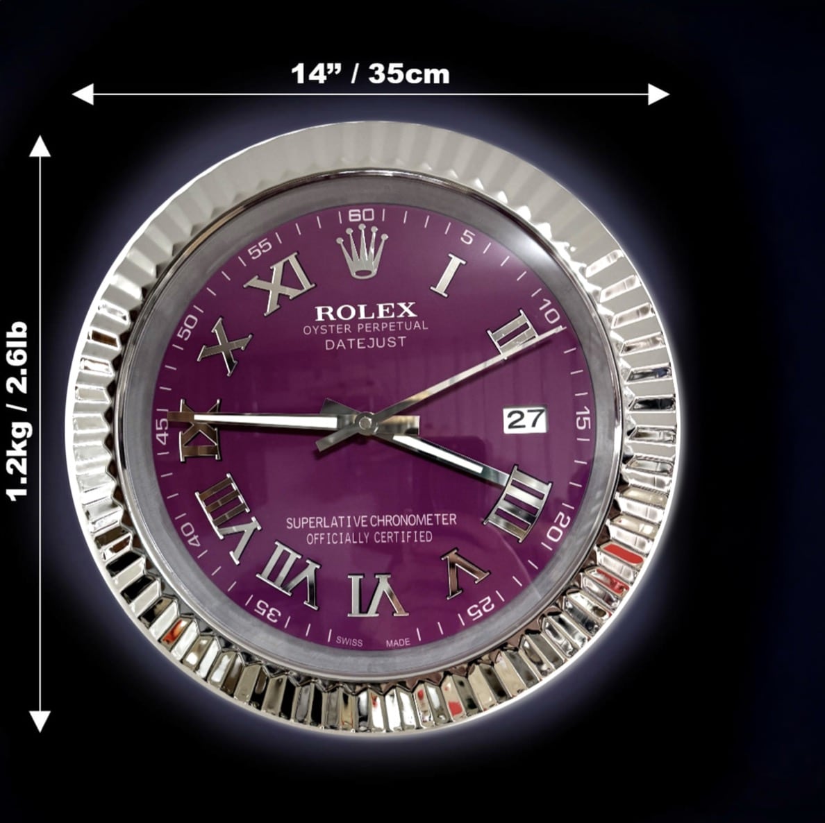 Round Rolex wall clock with a purple face, silver Roman numerals, and a fluted silver frame, showing dimensions 14 inches (35 cm) in diameter and weight 1.2 kg (2.6 lb) on a dark background.