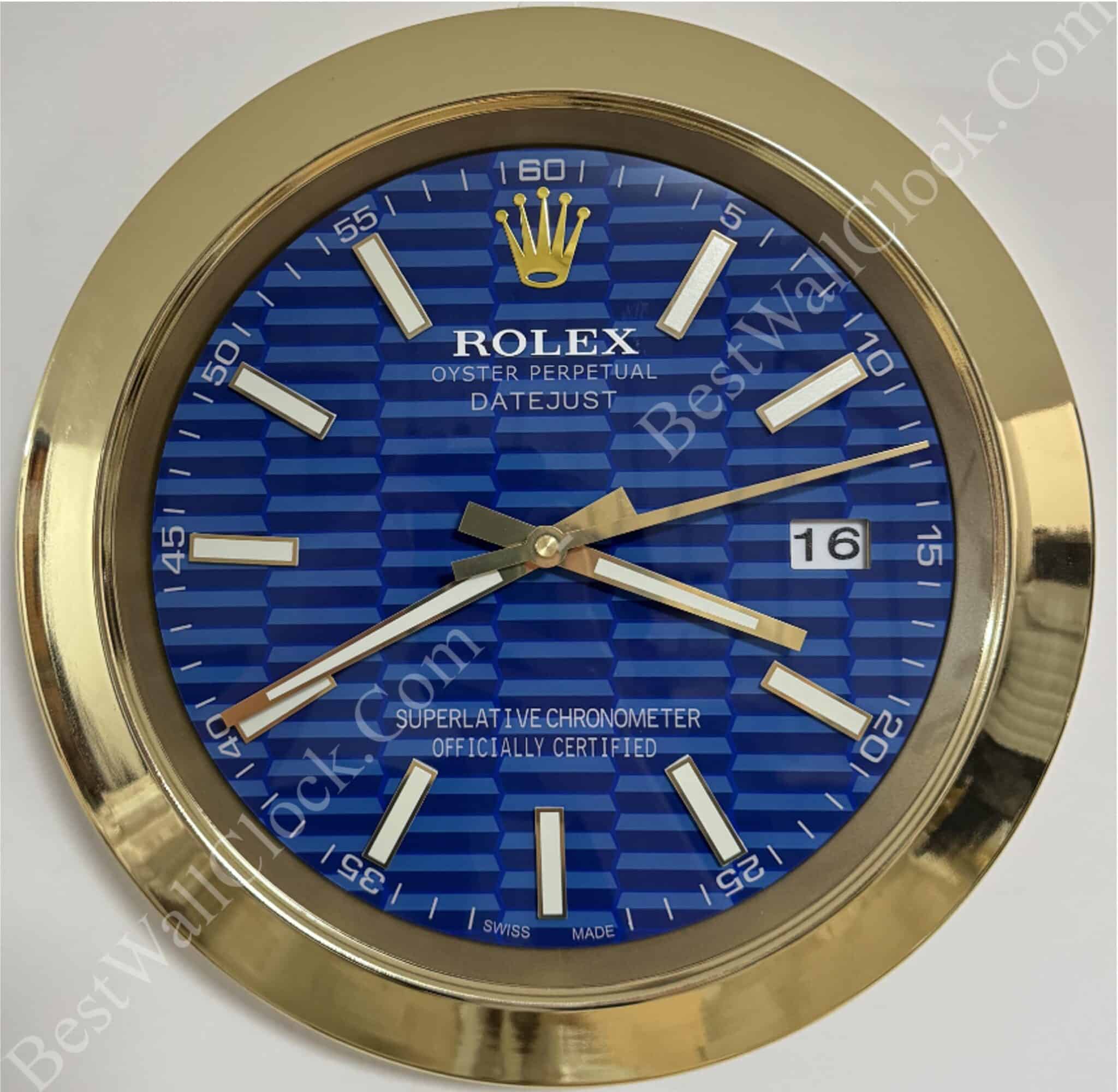 Gold-framed Rolex clock with a blue textured face displaying hour, minute, and second hands, a date window showing 16, and white rectangular hour markers.