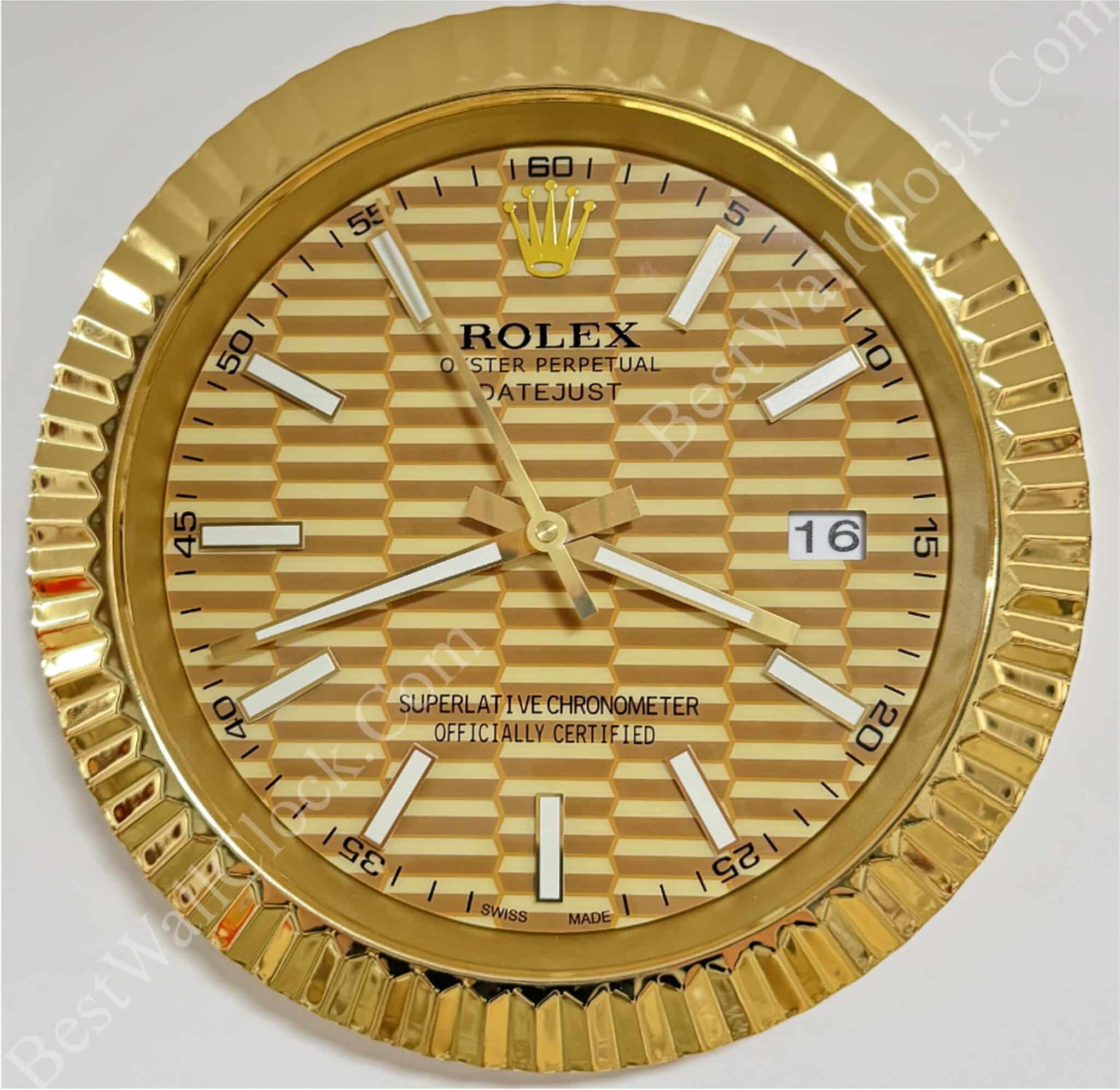 gold-tone wall clock with a textured three-dimensional honeycomb pattern on the face featuring white hour markers and hands, a date display at 3 o'clock, and the text "Rolex Oyster Perpetual Datejust Superlative Chronometer Officially Certified Swiss Made" below the 12 o'clock position, framed by a fluted gold bezel, rolex well clock