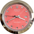 rolex well clock circular wall clock with a pink dial, silver hour markers shaped as small pyramids, silver hands, and a metal frame