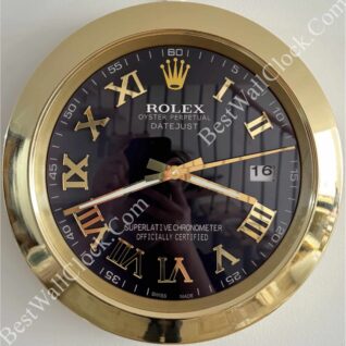 Close-up of a round Rolex Oyster Perpetual Datejust wall clock with a black face, gold Roman numerals, gold hour, minute and second hands, a gold frame, and a date window showing 16.