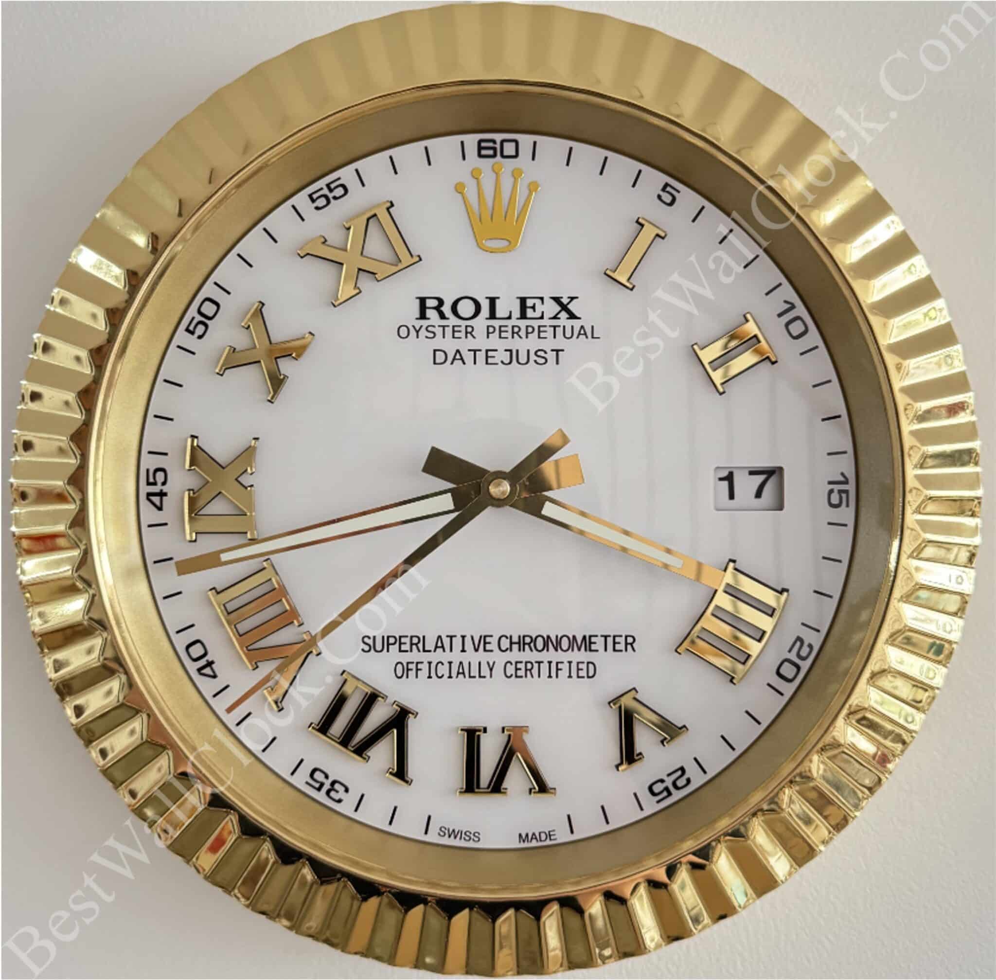 Gold-framed Rolex wall clock with Roman numerals, white face, and black text reading 'Rolex Oyster Perpetual Datejust Superlative Chronometer Officially Certified', showing the time 8:21:38 and date 17.