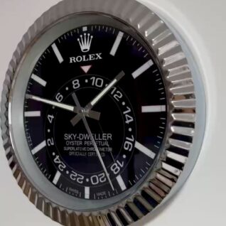 Close-up of a Rolex Sky-Dweller Oyster Perpetual watch face with black dial, white hour markers, and silver hands inside a fluted silver bezel.