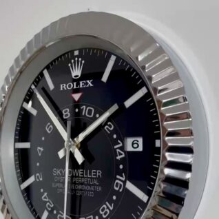 Close-up of a Rolex Sky-Dweller wristwatch with a black dial, silver hour markers, and a date window showing the 6th, encased in a fluted silver bezel.