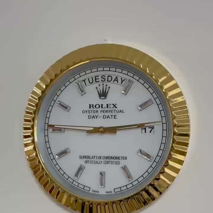 Close-up of a Rolex Oyster Perpetual Day-Date watch face with gold bezel, white dial showing the day as Salı, date as 17, and silver hour markers.