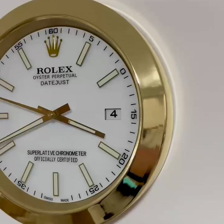 Close-up of a gold-framed Rolex Oyster Perpetual Datejust watch face with white dial showing time at 3:20 and date as the 4th.