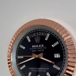 Close-up of a Rolex Oyster Perpetual Day-Date watch face with a black dial, diamond hour markers, a rose gold fluted bezel, displaying Tuesday and the date 17