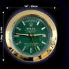 Close-up of a Rolex Oyster Perpetual Day-Date watch face with a green dial, gold bezel, day displayed as Dinsdag, and date as 27, with dimensions 14 inches / 35 cm diameter and weight 1.2 kg / 2.6 lb annotated around it.