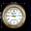 Wall clock styled like a Rolex Oyster Perpetual Day-Date watch with a gold fluted bezel, displaying the day as Salı and the date as 17, dimensions 14 inches (35 cm) in diameter and weight 1.2 kg (2.61 lbs) indicated with white arrows on a dark background.