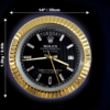Close-up of a black and gold Rolex wall clock with diamond-shaped hour markers, showing the day as Martedì and the date as 17, with measurements indicating 14 inches (35 cm) in diameter and weight of 1.2 kg (2.61 lbs) against a dark background.