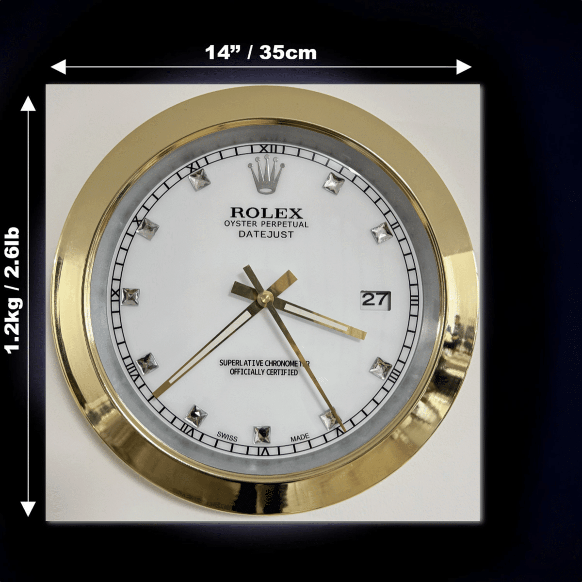 Square wall clock with a gold frame, white face, and diamond hour markers, styled to resemble a Rolex Oyster Perpetual Datejust watch, showing the time as 3:37:25 and the date as 27, with dimensions 14 inches by 14 inches and weight 1.2 kg indicated.