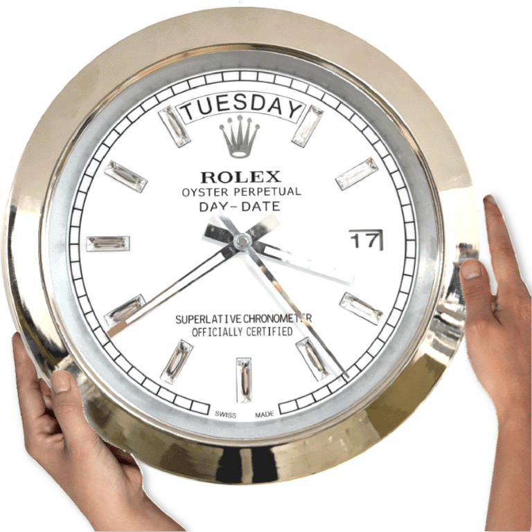 Two hands holding a large round Rolex wall clock displaying Martedì and the date 17 with a white face and silver hour markers and bezel