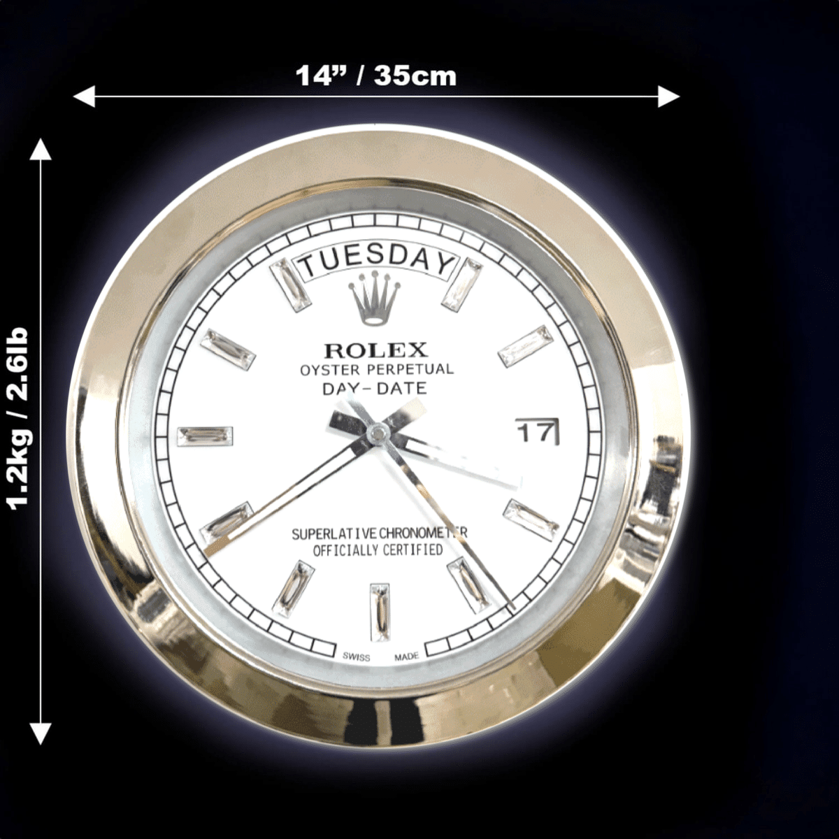 Rolex Oyster Perpetual Day-Date watch face with gold bezel, day displayed as Martedì, date as 17, hour markers as diamonds, dimensions marked as 14 inches (35 cm) in diameter and weighing 1.2 kg (2.6 lb) against a dark background.