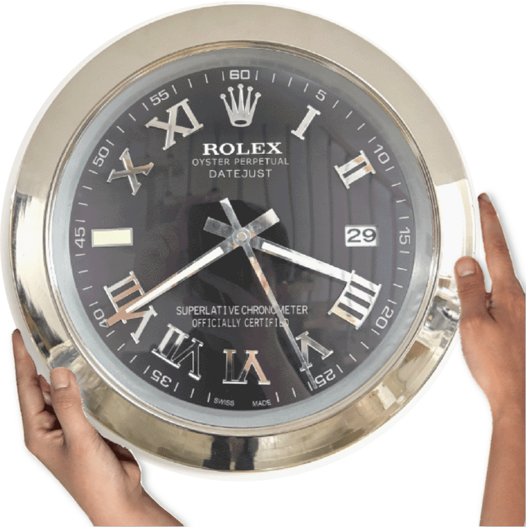 Hands holding a large round wall clock designed like a Rolex Oyster Perpetual Datejust watch with a black face, silver Roman numerals, and a date display showing 29.