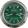 Close-up of a green Rolex Oyster Perpetual Day-Date watch face with silver hour markers, showing the day as terça-feira and the date as 26, encased in a reflective silver fluted bezel.