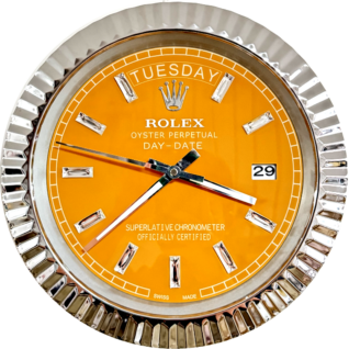 Close-up of a Rolex Oyster Perpetual Day-Date watch with an orange dial, silver hour markers, and a silver fluted bezel showing the day as Tuesday and the date as 29.
