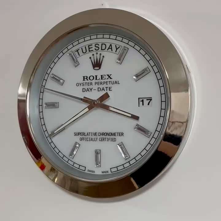 Close-up of a Rolex Oyster Perpetual Day-Date watch face showing Martedì and the date 17, with silver hour markers and hands on a white dial inside a silver bezel.