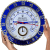Hands holding a round Rolex Yacht-Master II clock with a blue and white face and gold numbers around the edge.