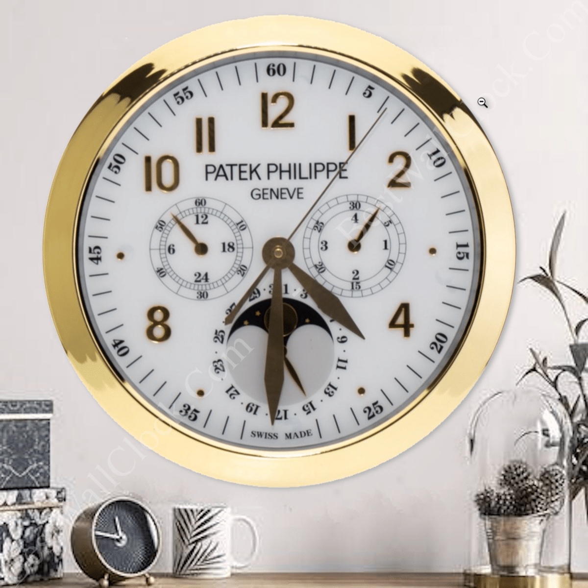 A gold-rimmed wall clock with multiple dials, including time, moon phase, and other features. Nearby are books, a small plant, and a round black object on a shelf.